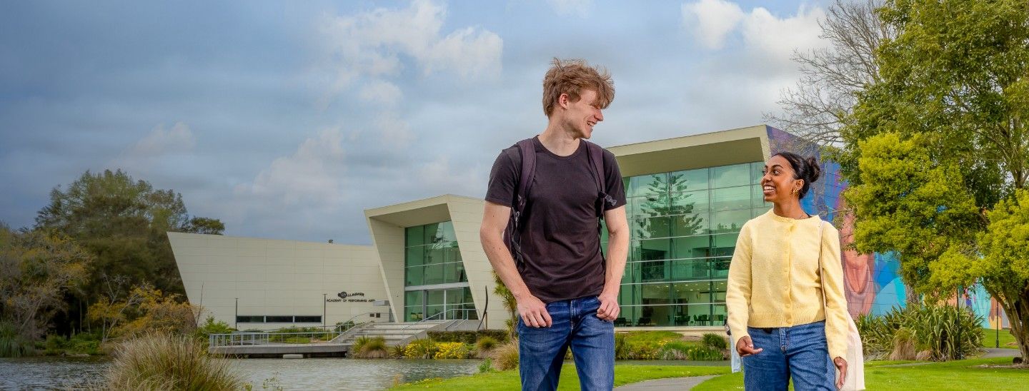 Male and female student walking outside in the college campus