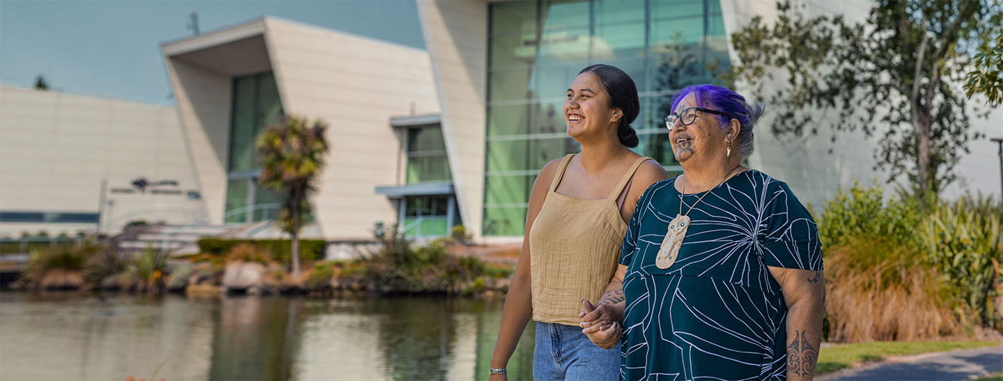 Maori people walking outside campus