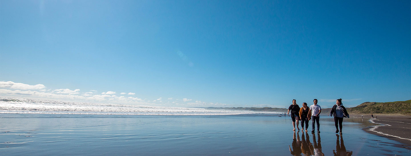 Students walking on the beach