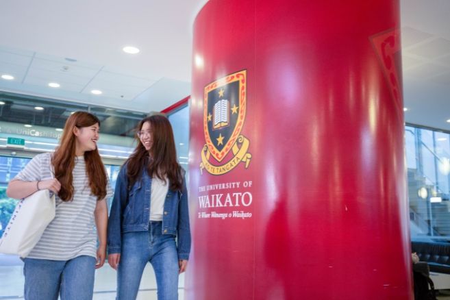 girl students discussion, laughing and walking in college